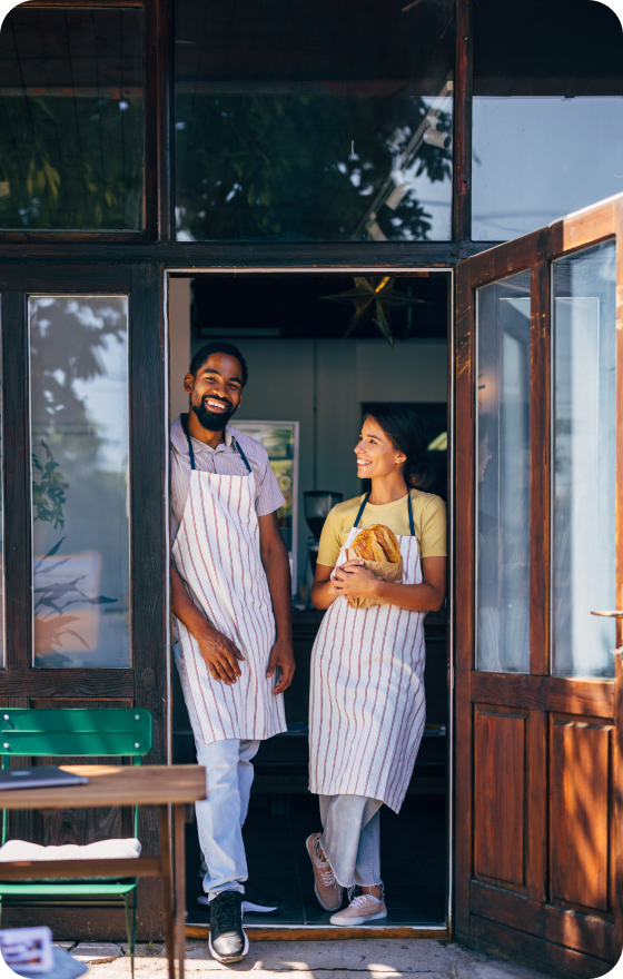 Two bakers standing with bread