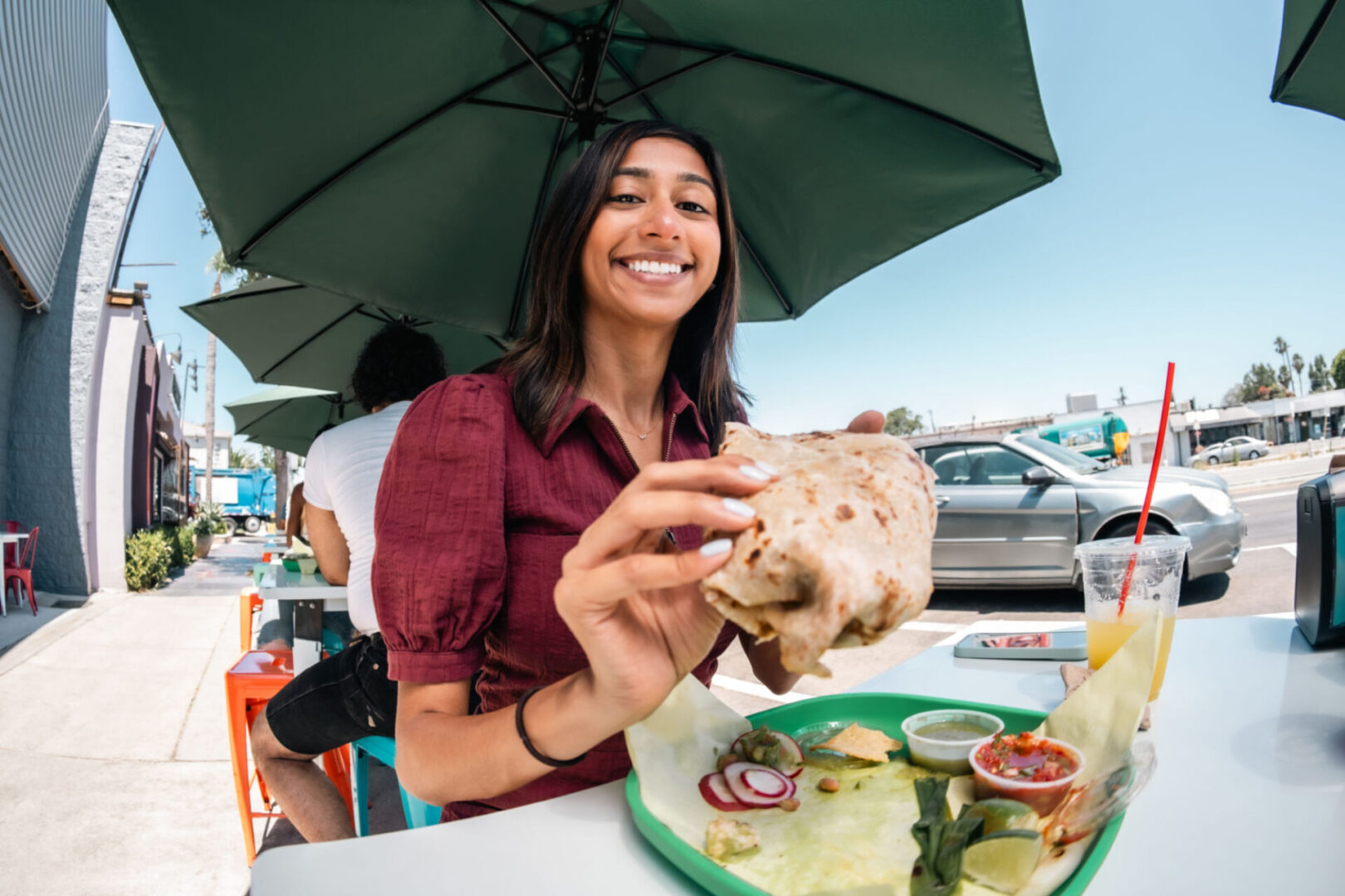Woman enjoying a burrito outdoors