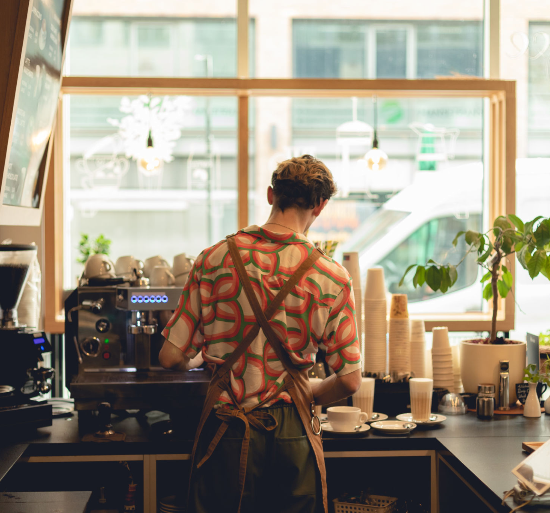 Barista preparing coffee at cafe counter